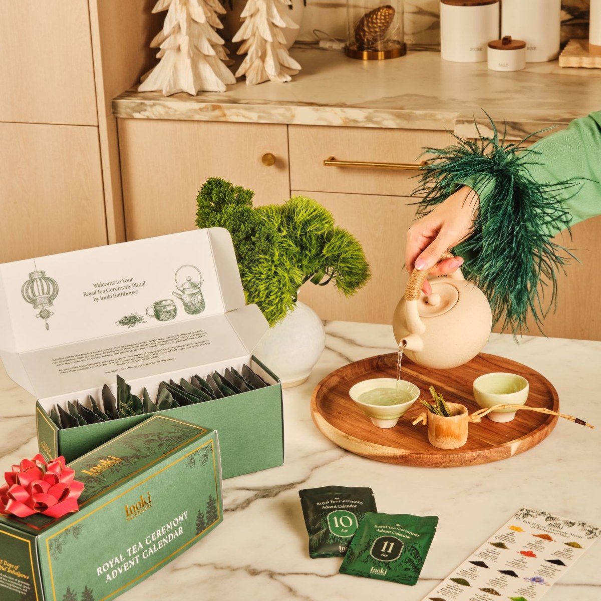 Pouring a full pot of tea beside the open advent calendar